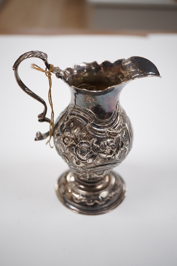 A George III silver inverted pyriform cream jug, with later embossed decoration, Charles Chesterman II, London, 1779?, height 11.4cm.